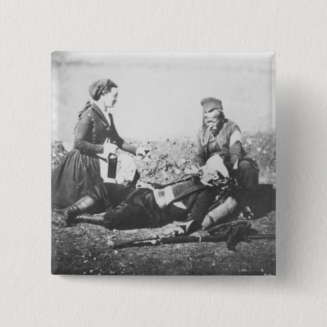 Chapa Cuadrada Una enfermera que tiende a un hombre herido (Anverso)