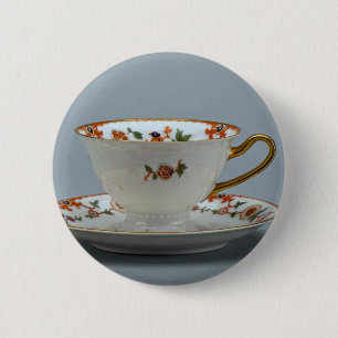 Chapa Redonda De 5 Cm Taza y platillo con las flores coloridas en él