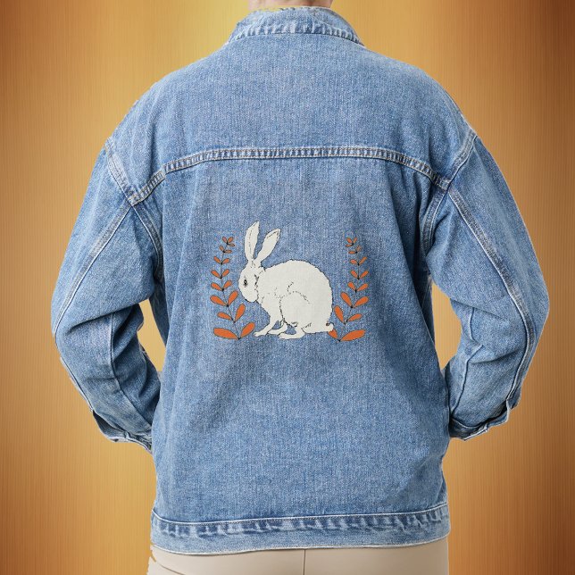 Chaqueta Vaquera Plantas de Naranja de conejito blanco floffy (Sitting white bunny with tall leafy orange plants on a denim jean jacket.)