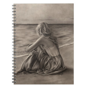 Chica en el cuaderno de la playa