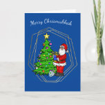 Chrismukkah Santa con tarjeta de Navidades Menorah<br><div class="desc">Esta tarjeta de Chrismukkah muestra a Santa Claus sosteniendo una menorah junto a un árbol de Navidad con una estrella y luces. Así que sus vacaciones pueden ser brillantes desde un árbol de Navidad o desde las velas en la Menorah. Bueno, esa es mi idea de todos modos. Pero, usted...</div>