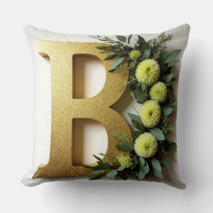 Cojín Decorativo Letra B dorada rodeada de arreglos florales