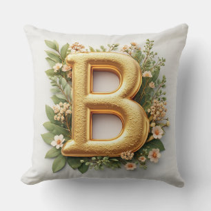 Cojín Decorativo Letra B dorada rodeada de arreglos florales