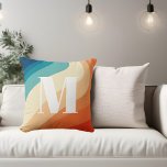 Cojín Decorativo Naranja azul arco iris retro monograma<br><div class="desc">Olas de arco iris retro en colores azul y naranja. Monograma en letra serif retro negrita.</div>