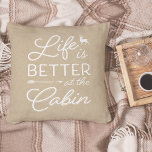 Cojín Decorativo Tan & White Life Is Better At The Cabin<br><div class="desc">Rustic modern throw pillow features a light tan beige background with "life is better at the cabin" overlaid in white typography. Personalize the reverse side with your family name and year established.</div>