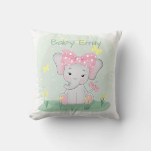 Cojín Decorativo Un elefante pequeño con una proa rosa en un claro