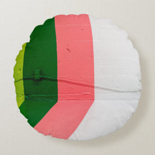 Cojín Redondo Muros pintados de blanco, rosa, verde y amarillo