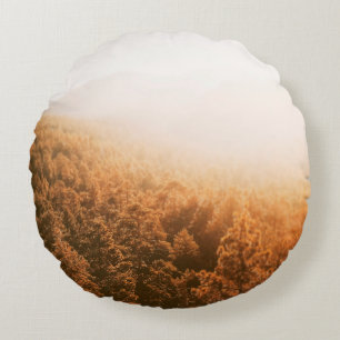 COJÍN REDONDO SOL DE ORO SOBRE UN BOSQUE