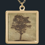 Collar Dorado Silueta de árbol sobre fondo de bronce<br><div class="desc">Un fondo de bronce es el escenario de esta silueta de un árbol con ramas que oscilan en la brisa. Casi sientes como si pudieras descansar tu espalda contra este árbol,  sentarte en el suelo y tomar una larga siesta.</div>