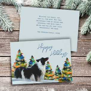 Collie de borde en árbol de navidad de nieve en in