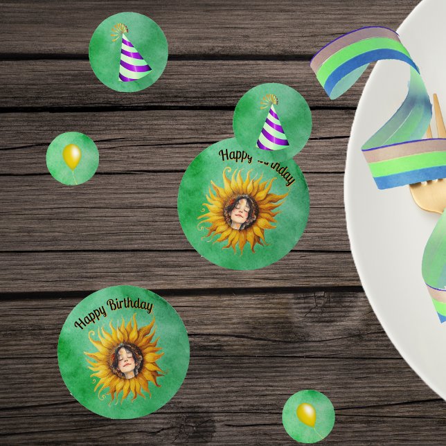 Confeti Birthday Girl Pretty Face in Sunflower Hats Green (Pretty girl in big yellow sunflower, party hats, yellow balloons on green table Birthday confetti.)