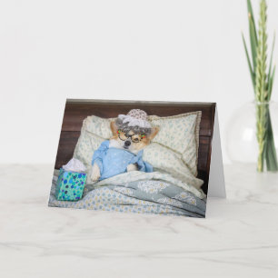 Corgi en la cama consigue una tarjeta de bienvenid