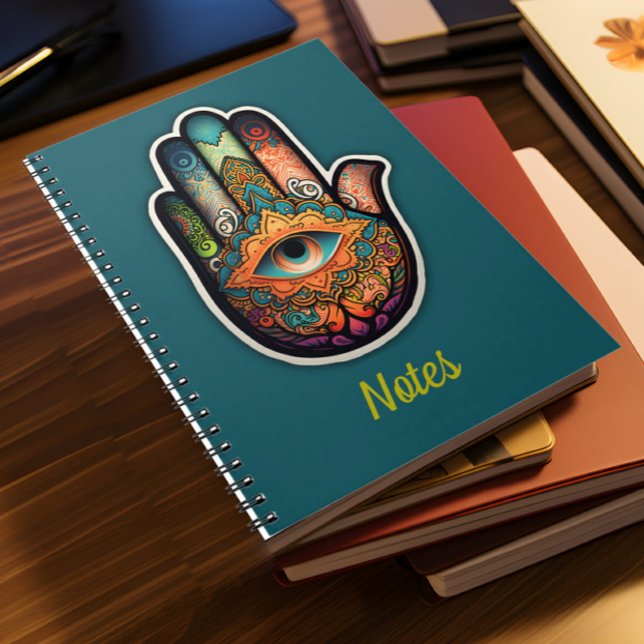 Cuaderno Bloc de notas en espiral de mano de Hamsa (A pile of notebooks lies on a desk)