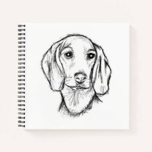 Cuaderno boceto de perro salchicha dibujado a mano en negro