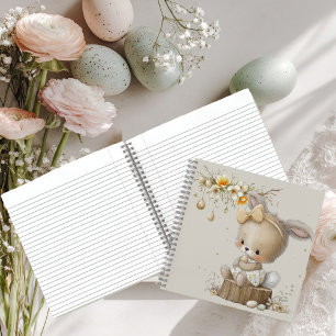 Cuaderno conejo lindo con huevos de Pascua en un prado de f