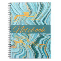 cuaderno de color aqua y dorado