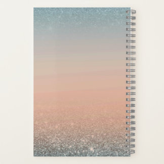 Cuaderno de color turquesa y naranja con purpurina