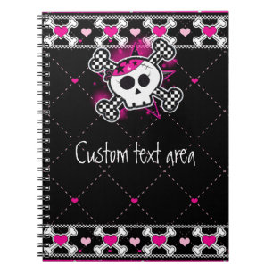 Cuaderno de cráneos rosados con huesos cruzados y