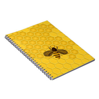 Cuaderno del panal del oro con la abeja