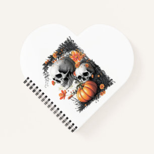 Cuaderno Dos cráneos y una calabaza entre las flores.