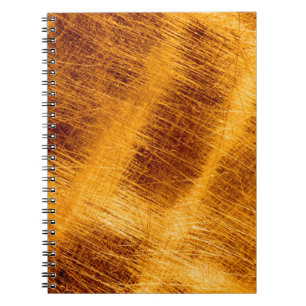 Cuaderno Escrates sobre un fondo metálico de oro. abstracto