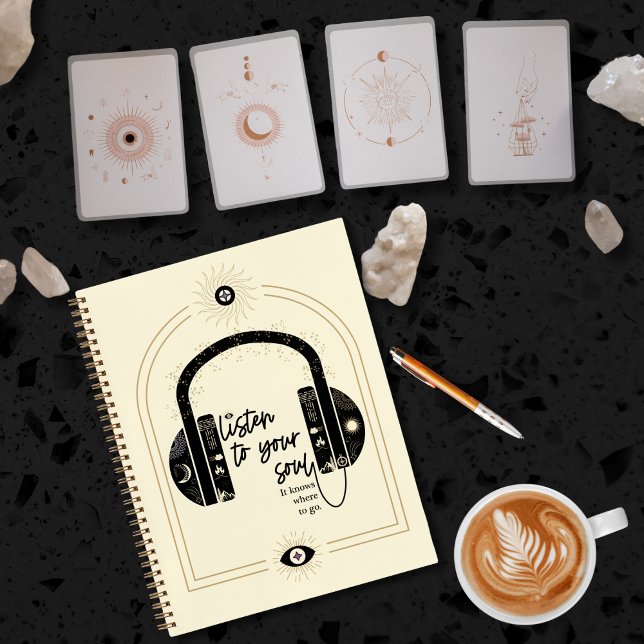 Cuaderno Escucha tu alma (Listen to your soul notebook with black headphones and celestial symbols.)