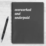 Cuaderno Funny Overworked and Underpaid Work Quote<br><div class="desc">A funny, humorous (and probably true!) notebook with a dark grey background and modern, bold white typography that reads "Overworked and underpaid". A little subtle hint for your workplace perhaps?</div>