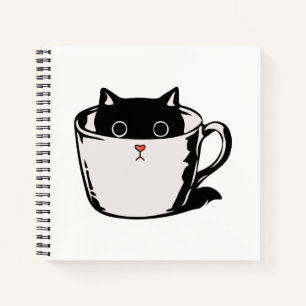 Cuaderno Gatito negro con nariz roja escondido en una taza
