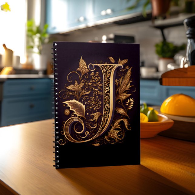 Cuaderno Letra monográfica J (Notebook with monogram letter J stands on kitchen table)
