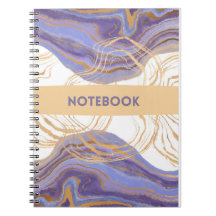 cuaderno morado, dorado y blanco