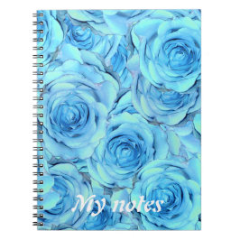 Cuaderno Opulento diseño rosa en un portátil turquesa