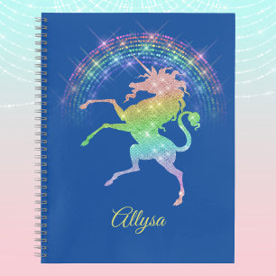 Cuaderno Parcialmente sonriente unicornio contra el arcoiri