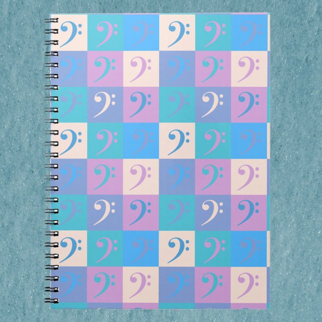 Cuaderno Patrón de Clave de Fa Pastel (A notebook with a pattern of bass clef music symbols in blue, yellow, pink and purple.)