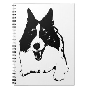 Cuaderno Planes al lado de un Corgi