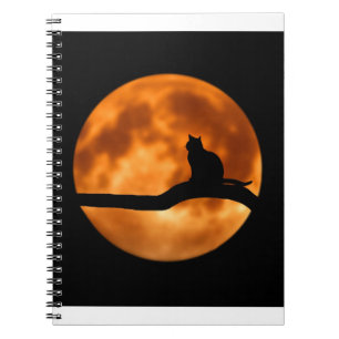 Cuaderno Silueta de un gato negro en un árbol