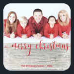 Cuadrada Rustic Wood Merry Christmas - Pegatina de fotos<br><div class="desc">Moderno ilustracion de moda Navidades de vacaciones con un fondo rústico de madera y un guión de tipografía roja "Feliz Navidad" en el texto y copos de nieve y bokeh decorativos. Cambiar fácilmente la foto de muestra con la suya.</div>