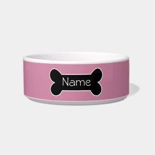 Cuenco rosado del perro con el hueso