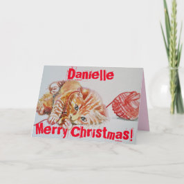 Cute Ginger Tabby Cat Jugando la tarjeta de Navida