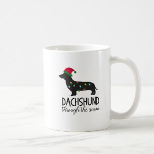 Dachshund a través de la taza de la nieve, navidad