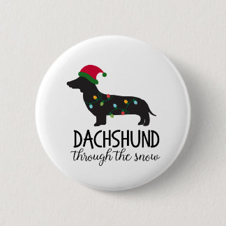 Dachshund a través del botón de la nieve, navidad