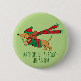 Dachshund a través del botón de Navidad de nieve