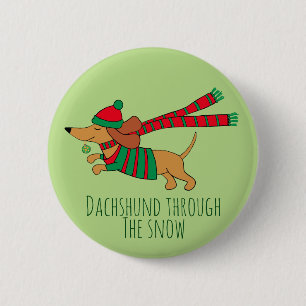 Dachshund a través del botón de Navidad de nieve