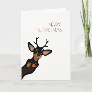 Dachshund lindo con Felices Navidad de las astas