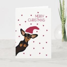 Dachshund lindo con Felices Navidad del gorra de