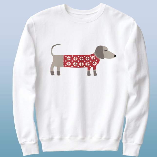 Dachshund Perro Navidades de diversión suéter (Unisex sweatshirt featuring a Dachshund Sausage or Wiener dog in festive red and white knitwear)