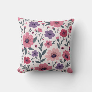 Decorativo Es un cojín mezclado con flores rosas y moradas.