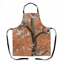 Árbol de albaricoque en flor junto a pared de ladr
