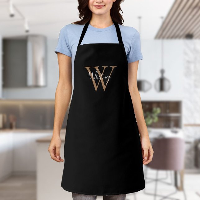 Delantal con monograma inicial de oro negro con le (Elegant Script Initial Black Gold Monogram Apron)