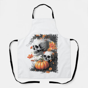 Delantal Dos cráneos y una calabaza entre las flores.