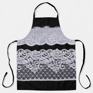 Delantal encaje blanco ornamental, fondo negro aislado.